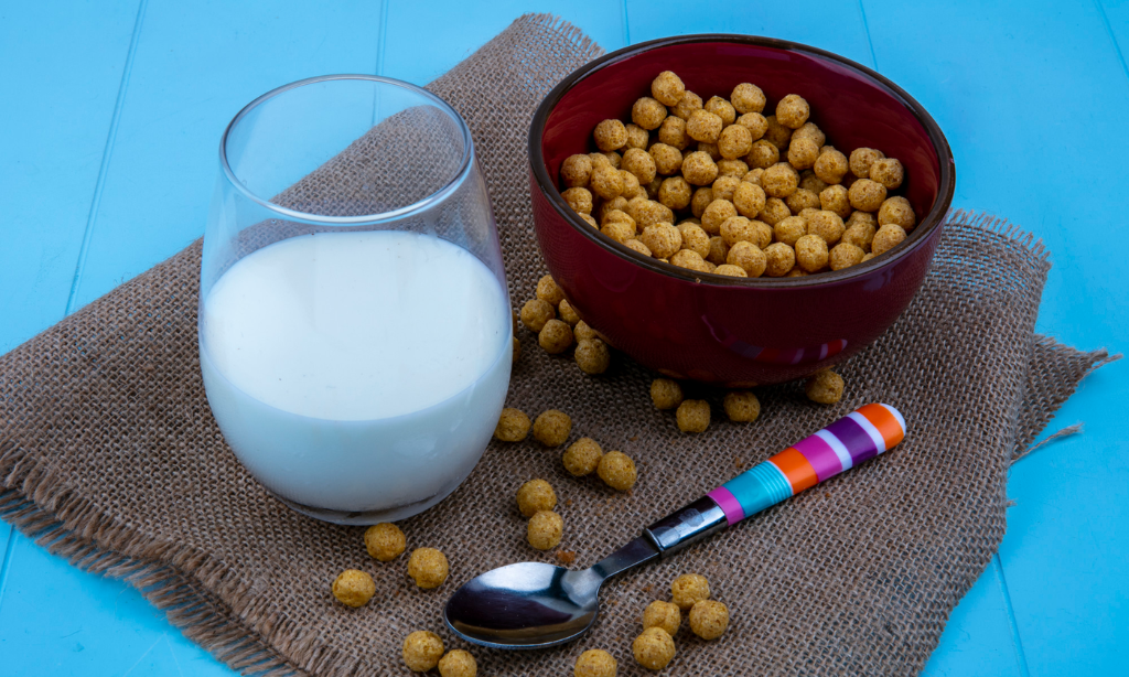 Milk and probiotic cereal on table, illustrating everyday probiotic intake compared with fermented foods like natto.