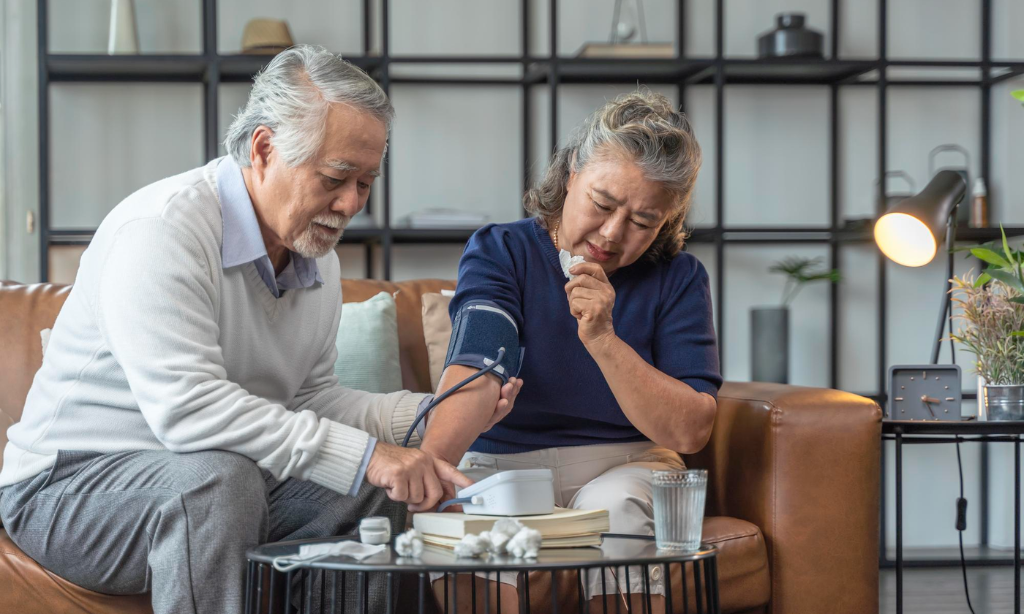 Older couple monitoring blood pressure at home as part of long-term heart health and healthy aging habits.