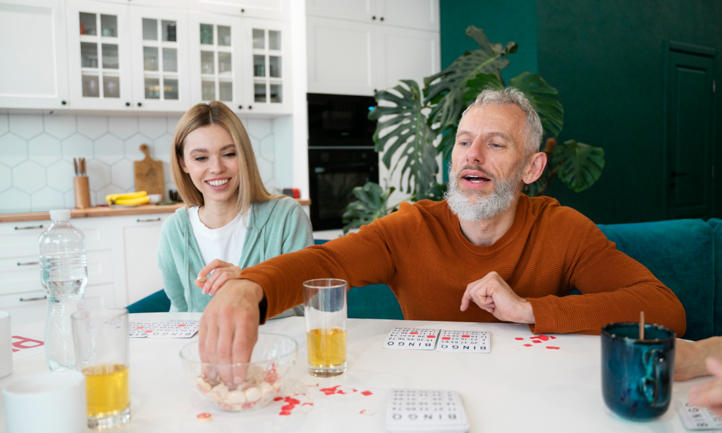 Middle-aged couple enjoying social activities at home, illustrating healthy ageing, wellbeing, and lifestyle habits linked to longevity and overall wellness.