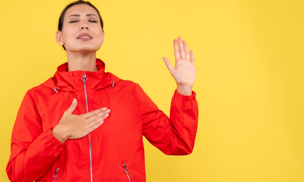 Woman practicing mindful breathing with hand on chest, symbolizing cardiovascular wellness, circulation health, and overall wellbeing.