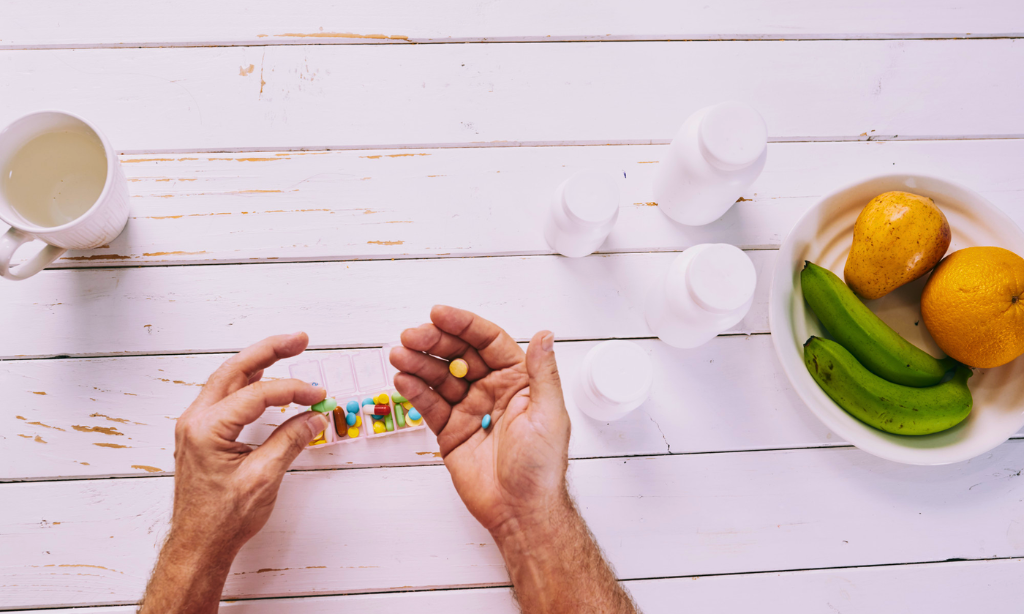 Capsules and supplements with fruits on table representing traditional health foods vs modern supplements for gut health and nutrition