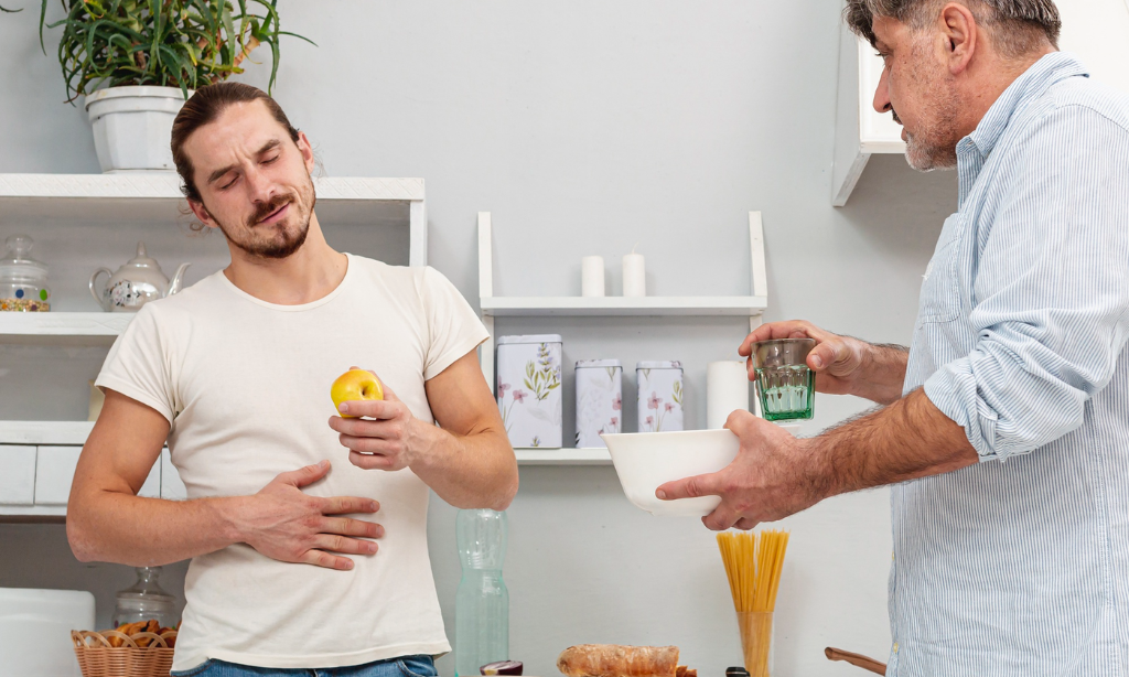 Man experiencing stomach pain showing gut health and digestion issues at home