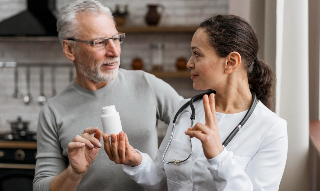 Healthcare professional showing vegan nattokinase capsules to an older adult while discussing how to choose a quality wellness supplement.