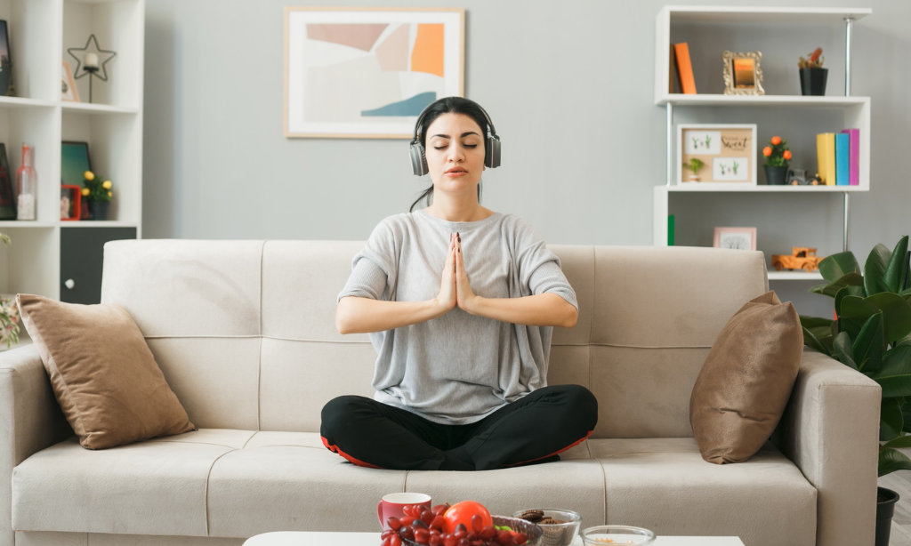 Woman practising mindfulness and relaxation at home during Mental Health Awareness Week, highlighting rest, recovery, and modern wellness habits.