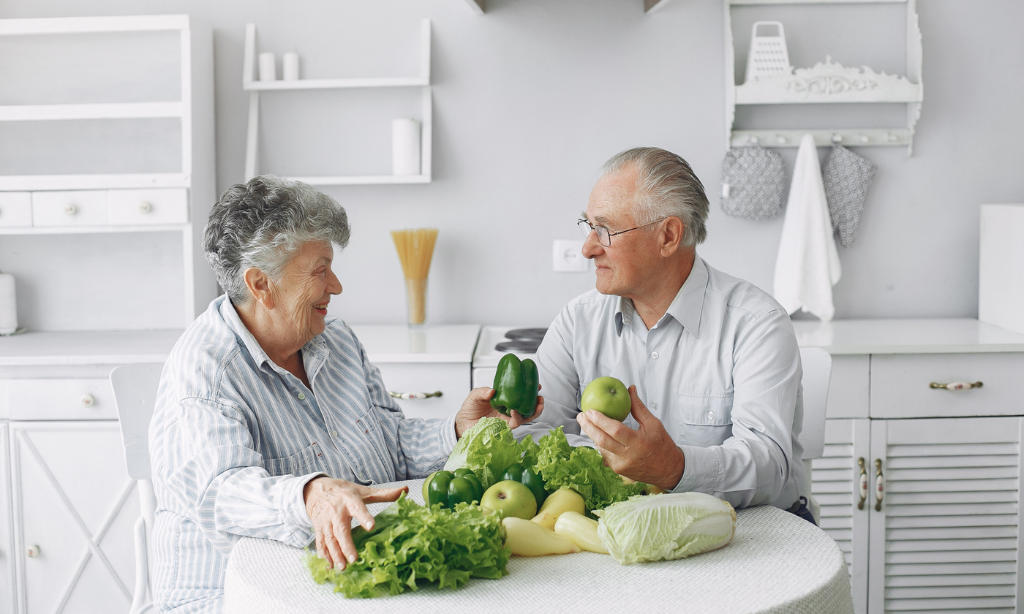 Older adults enjoying fresh vegetables and a healthy lifestyle, illustrating the connection between gut health, nutrition, and healthy ageing.