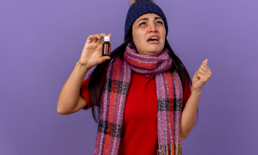 Woman reacting to a strong smell while holding a small supplement bottle, representing odor sensitivity, supplement experience, and natto product smell differences.