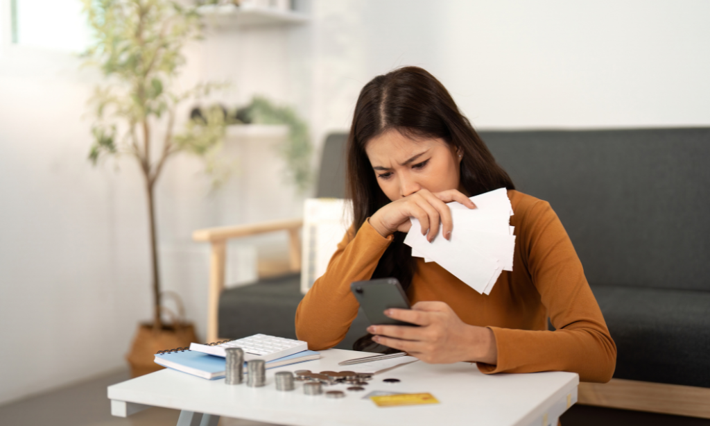 Woman comparing expenses and researching supplement prices, illustrating why Sonomono supplements cost more due to ingredient quality and manufacturing standards.